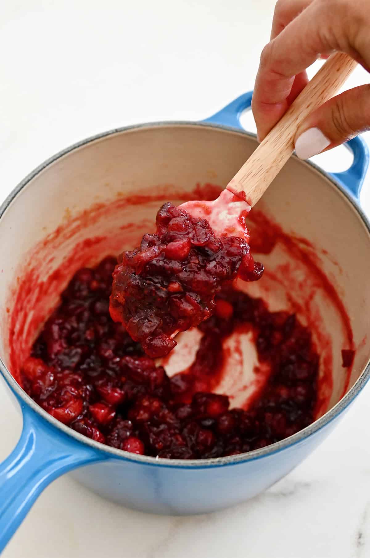 Homemade cranberry sauce is thickened enough to coat a spatula.