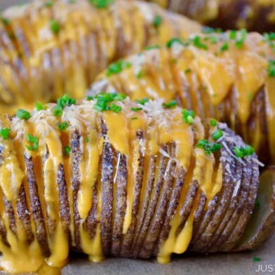 Hasselback potatoes filled with cheese and topped with chives
