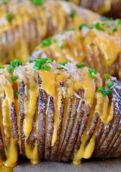 Hasselback potatoes filled with cheese and topped with chives