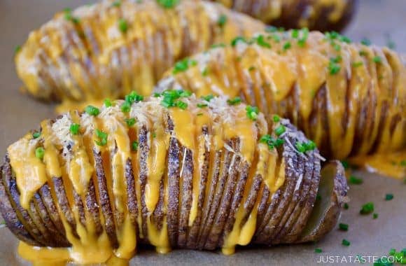 Hasselback potatoes filled with cheese and topped with chives