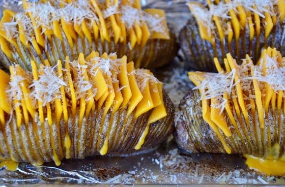 Filling sliced hasselback potatoes with cheese