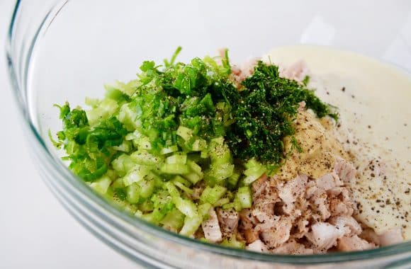 A clear bowl containing chopped up ingredients for Leftover Turkey Salad