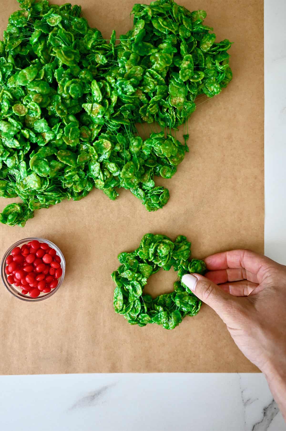 Shaping cornflake wreath cookies.