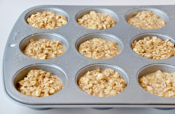 Greased muffin tin with Baked Oatmeal Cups batter 