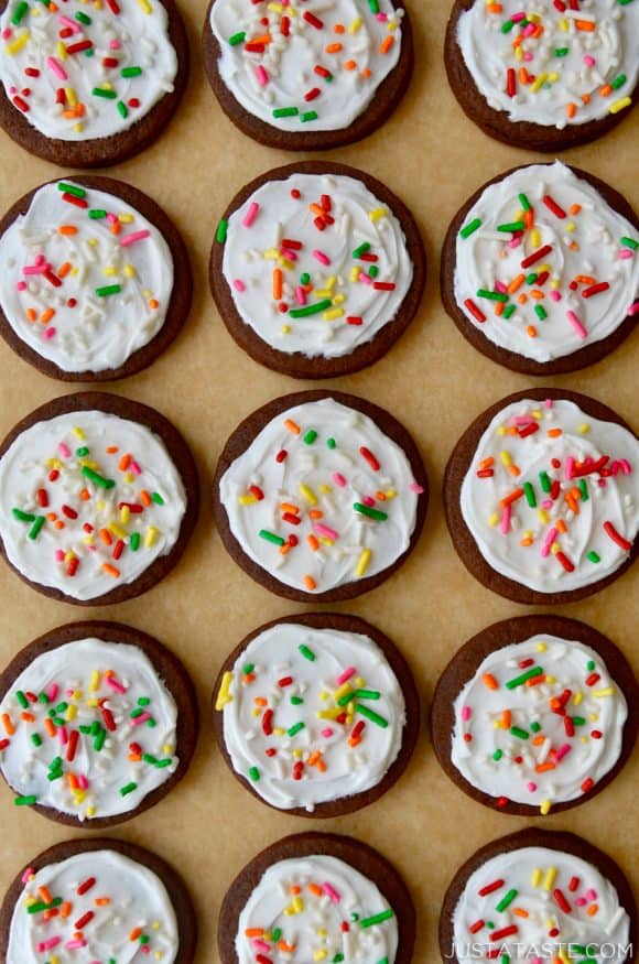 Rows of frosted homemade Chocolate Sugar Cookies on tan parchment paper