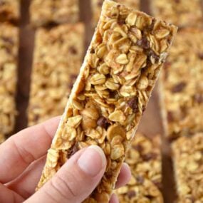 Holding a Homemade Peanut Butter Granola Bar with more granola bars in the background