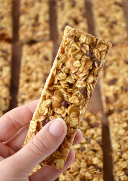 Holding a Homemade Peanut Butter Granola Bar with more granola bars in the background
