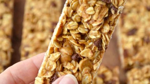 Holding a Homemade Peanut Butter Granola Bar with more granola bars in the background