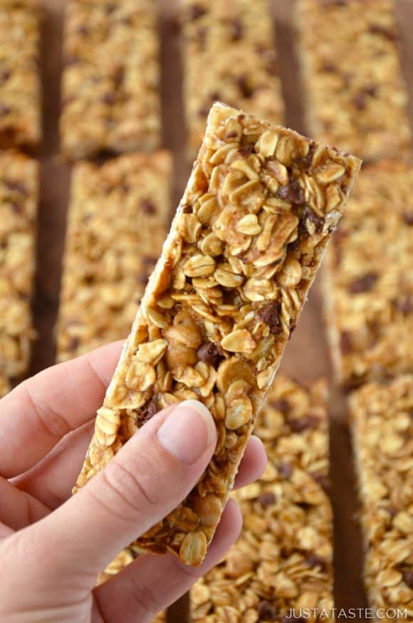 Holding a Homemade Peanut Butter Granola Bar with more granola bars in the background