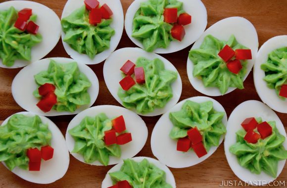 A wood platter with an overhead shot of Christmas Deviled Eggs