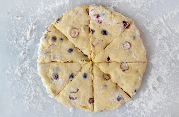 Dough cut into triangles on floured work surface