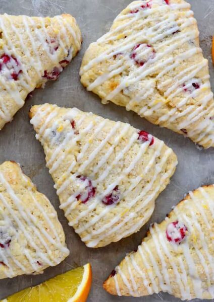 Orange Cranberry Scones on gray background with orange slices