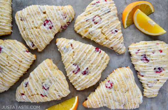 Orange Cranberry Scones on gray background with orange slices