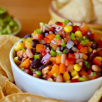 Cowboy caviar in a bowl surrounded by tortilla chips.