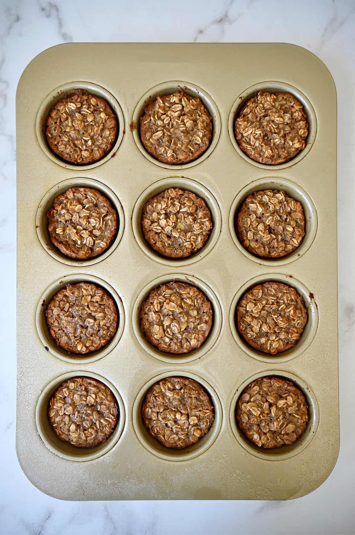 Freshly baked oatmeal in a muffin pan.