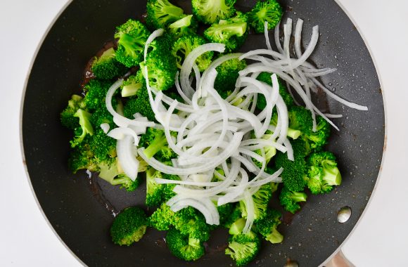 Broccoli and onions in nonstick sauté pan.