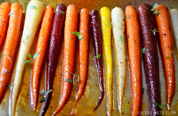 Multi-colored Easy Honey Roasted Carrots on aluminum foil.