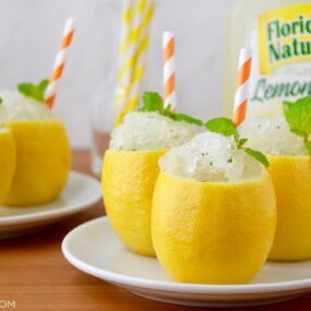 White plates with hollowed out lemons filled with Easy Lemon Granita