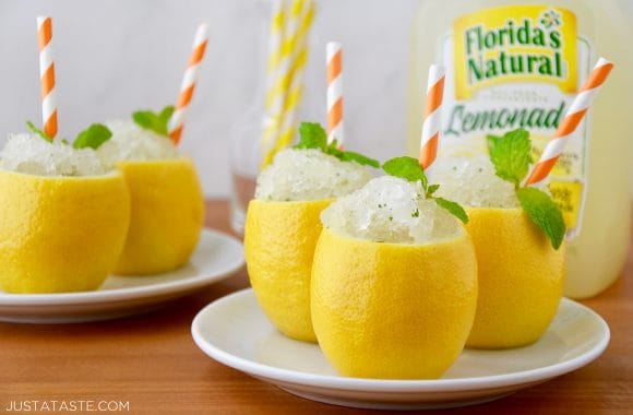 White plates with hollowed out lemons filled with Easy Lemon Granita 
