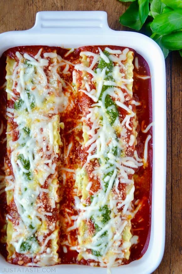 Easy Pesto Lasagna Roll-Ups in a white baking dish with marinara sauce