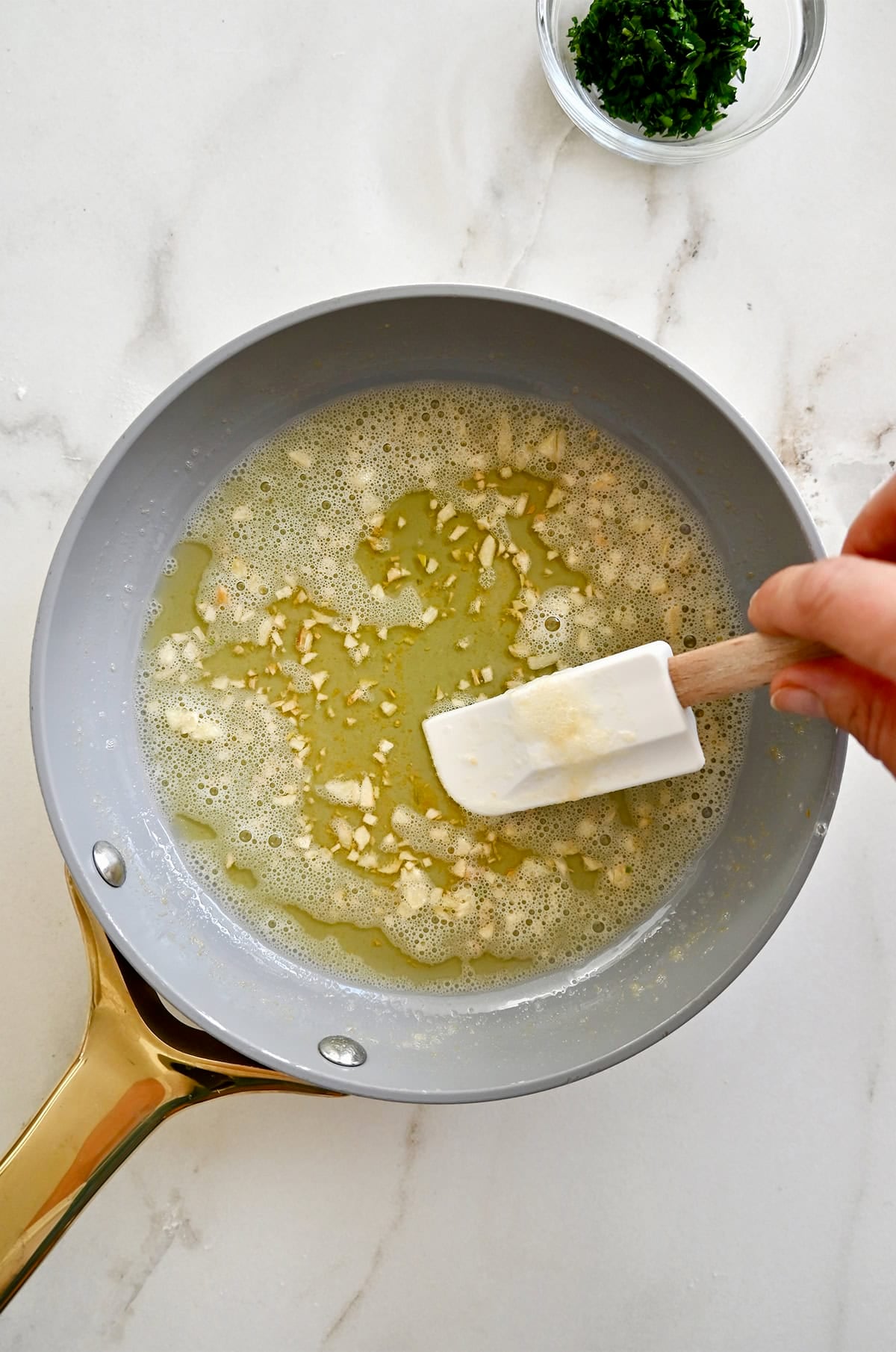 Making garlic butter in a small saucepan.