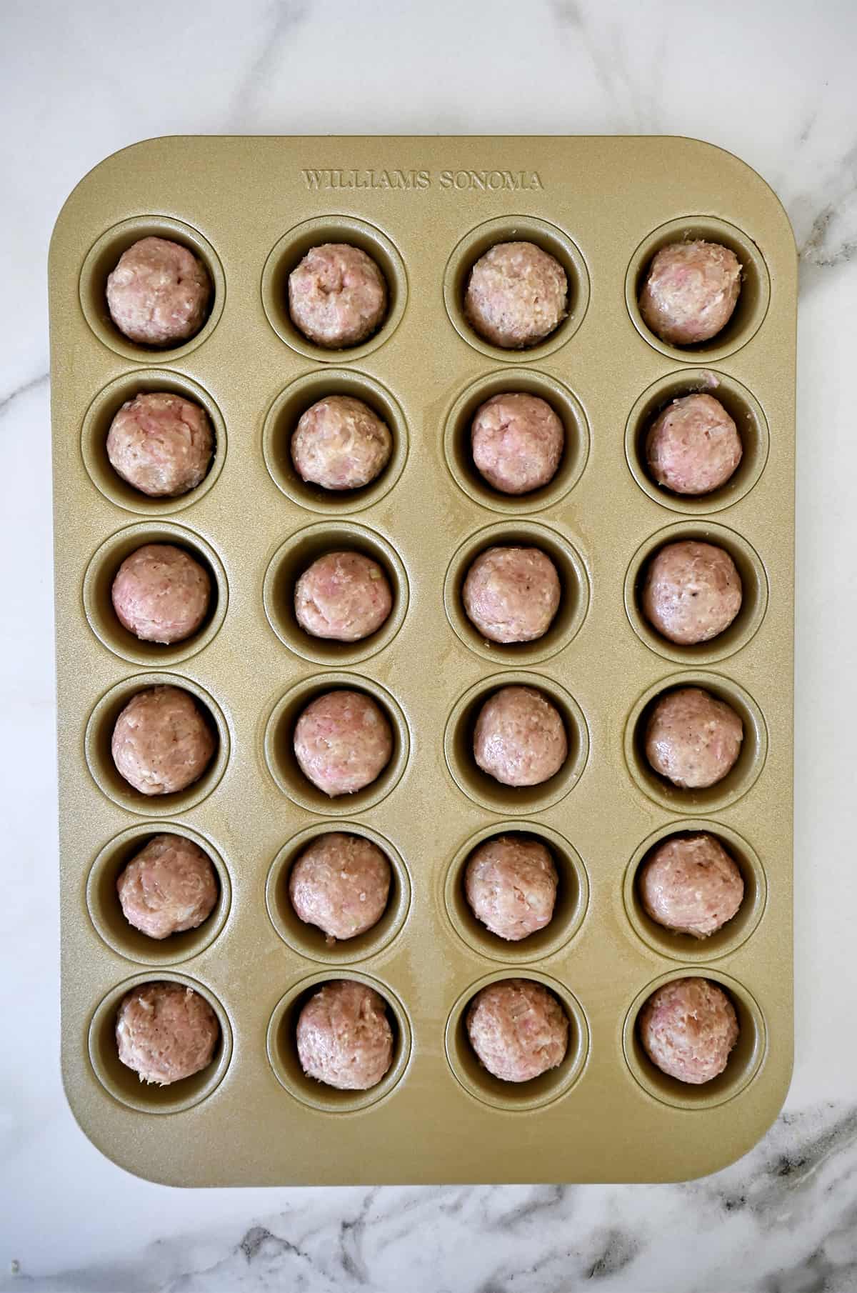 Mini meatballs in a mini muffin pan.