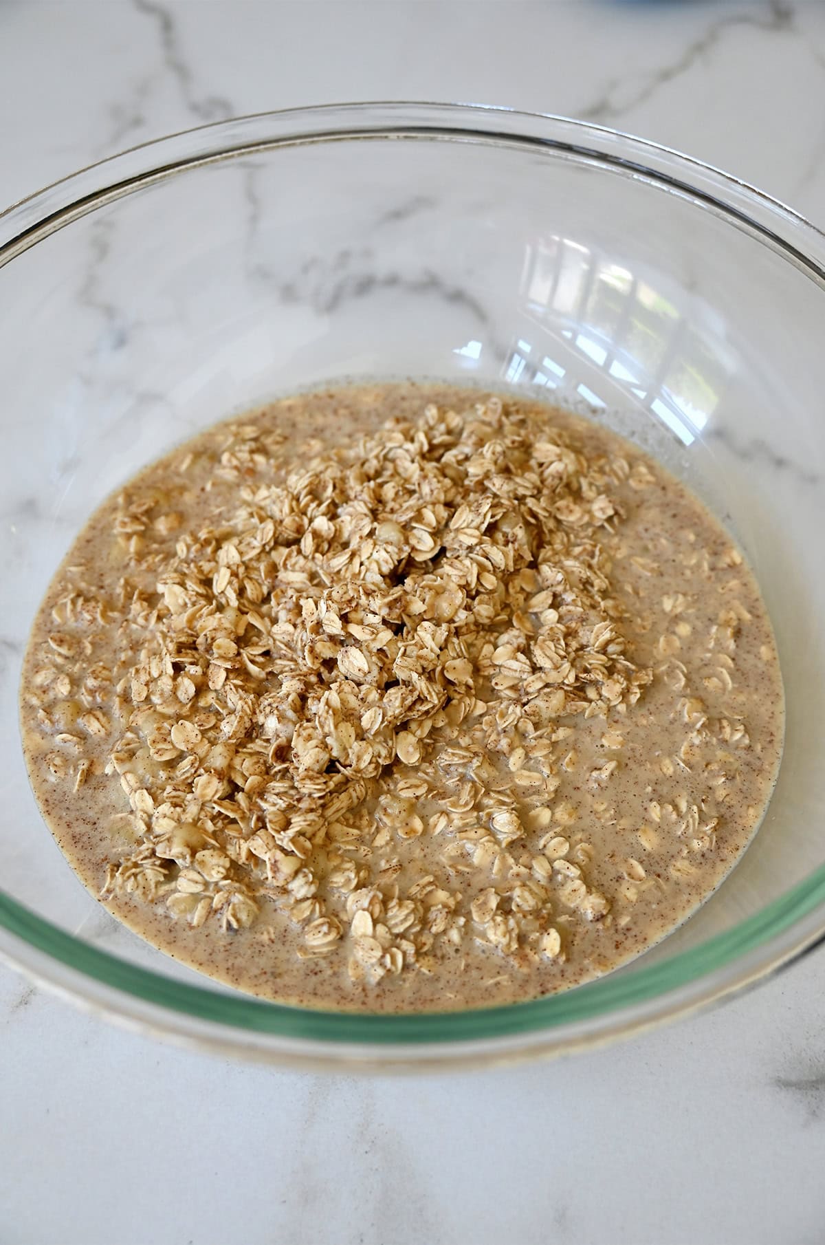 Oatmeal mixture in a glass bowl.