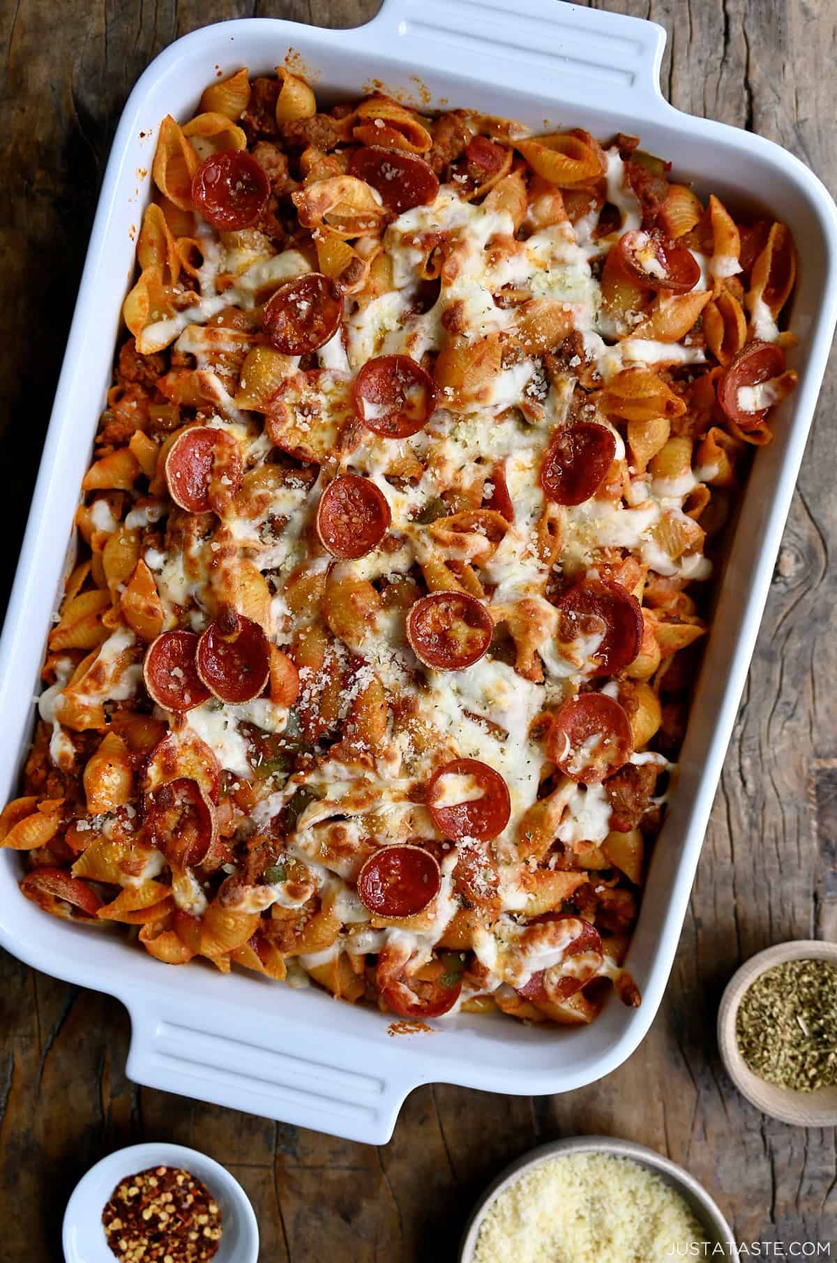 A baked pasta in a casserole dish with pepperoni, marinara sauce and plenty of gooey mozzarella cheese.