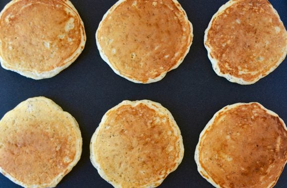 Six Lemon Poppyseed Pancakes on griddle. 