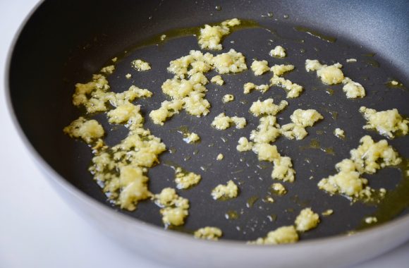 Sautéed garlic with olive oil in large saucepan
