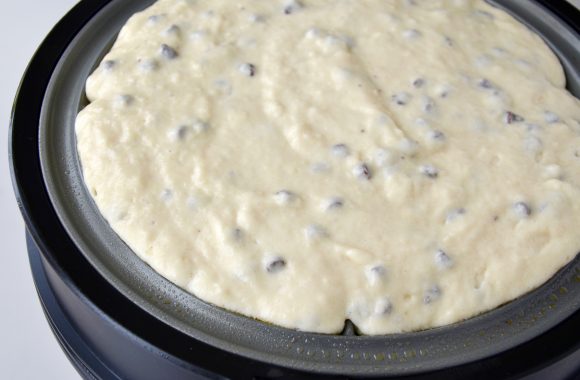 Buttermilk chocolate chip waffle batter in waffle maker.