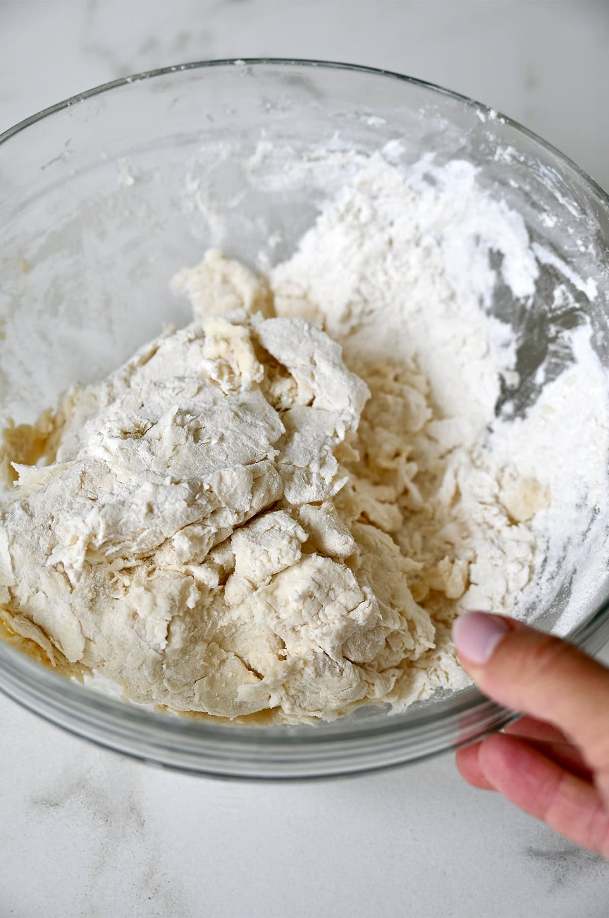 Shaggy shortcake dough in a glass bowl.