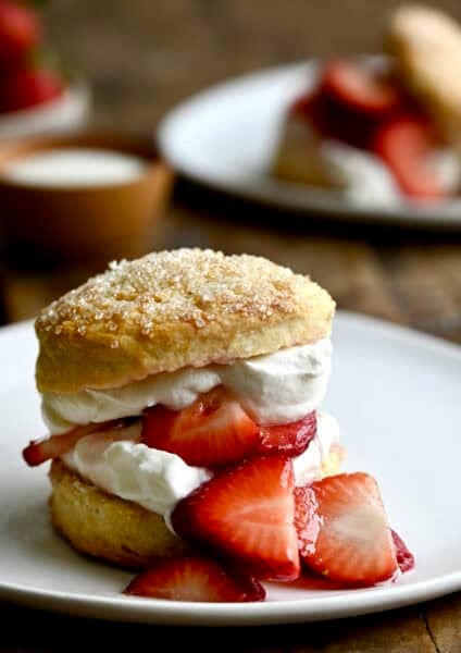 Strawberry shortcake dessert with macerated strawberries and freshly whipped cream.