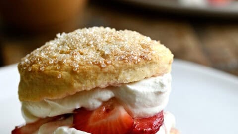 Strawberry shortcake dessert with macerated strawberries and freshly whipped cream.
