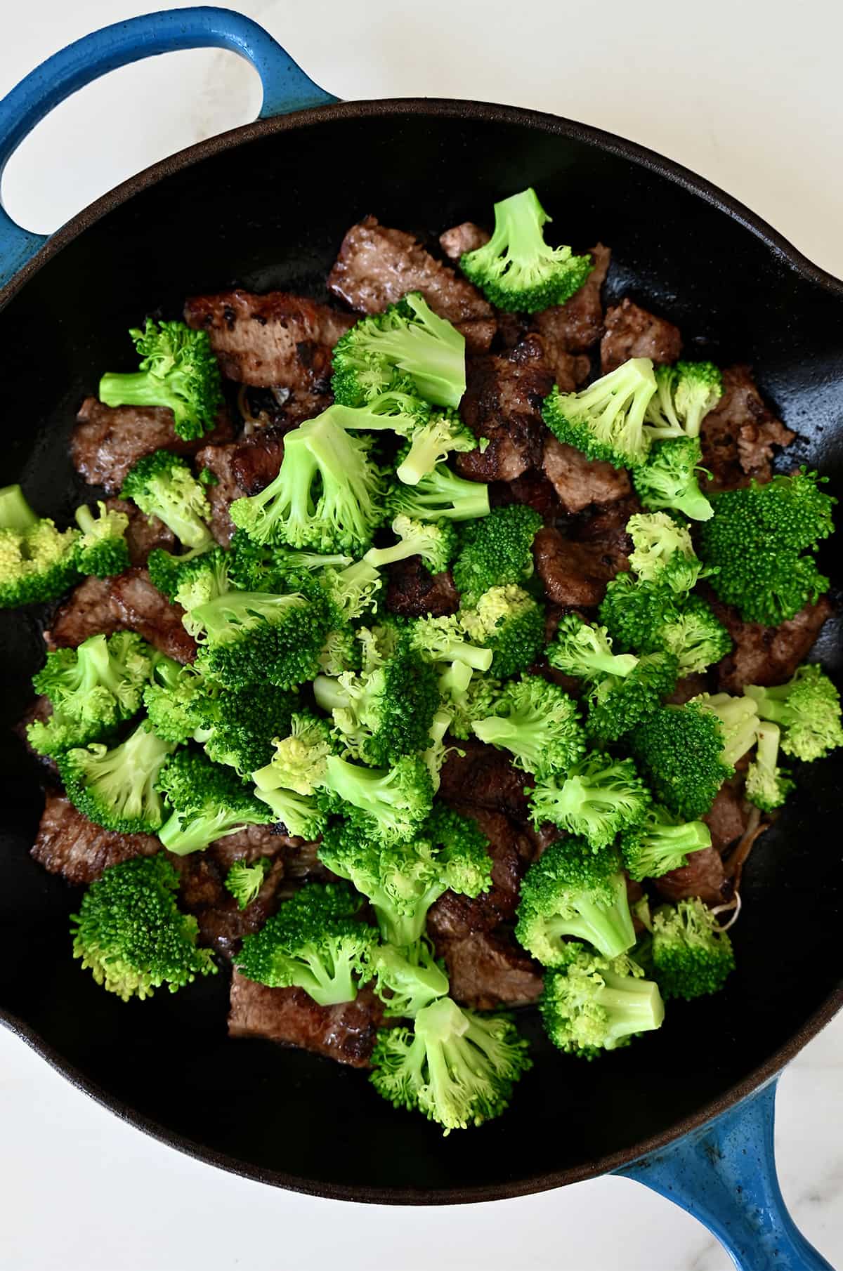 Stir-fried broccoli and beef in a large skillet.