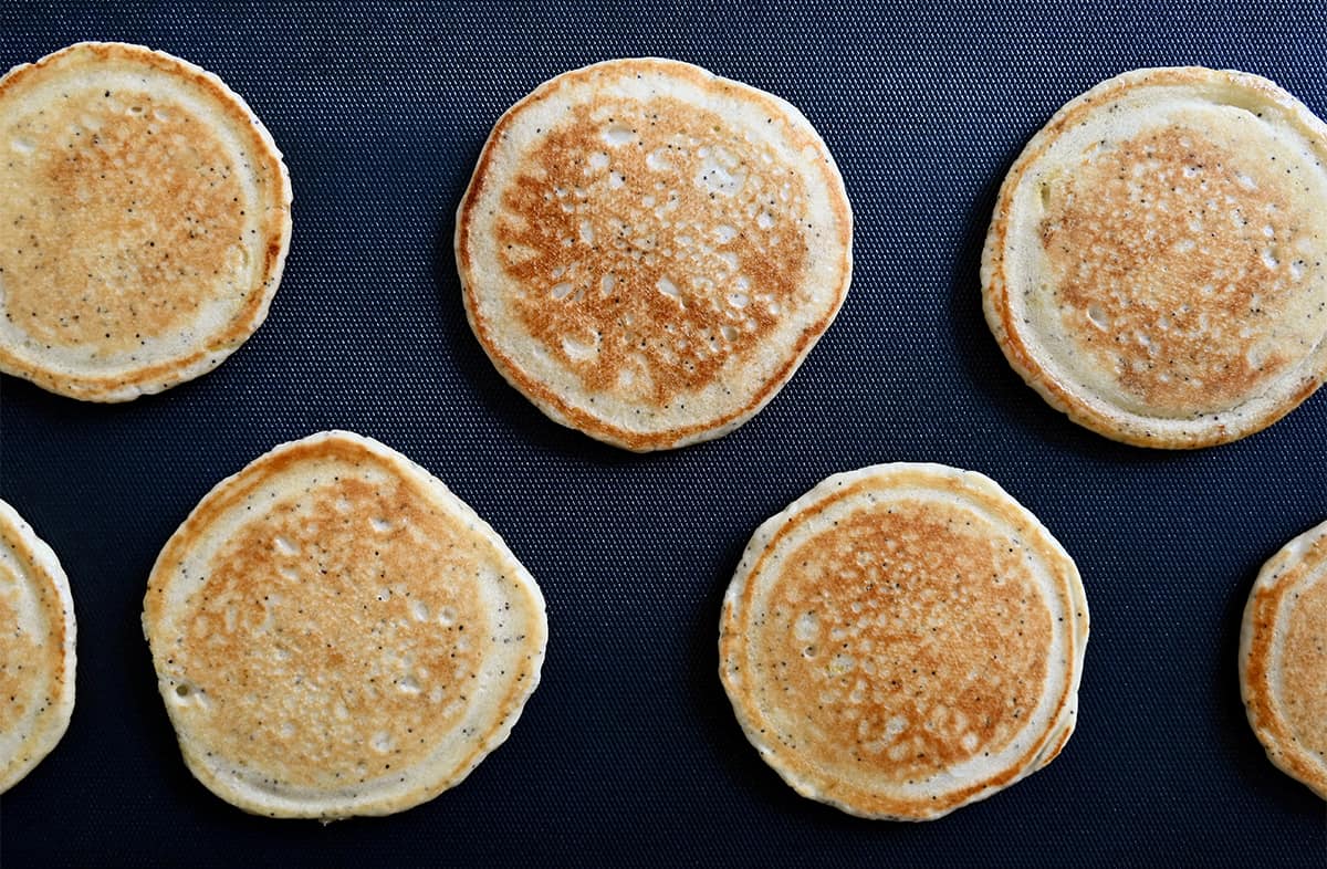 A top-down view of pancakes on a griddle.