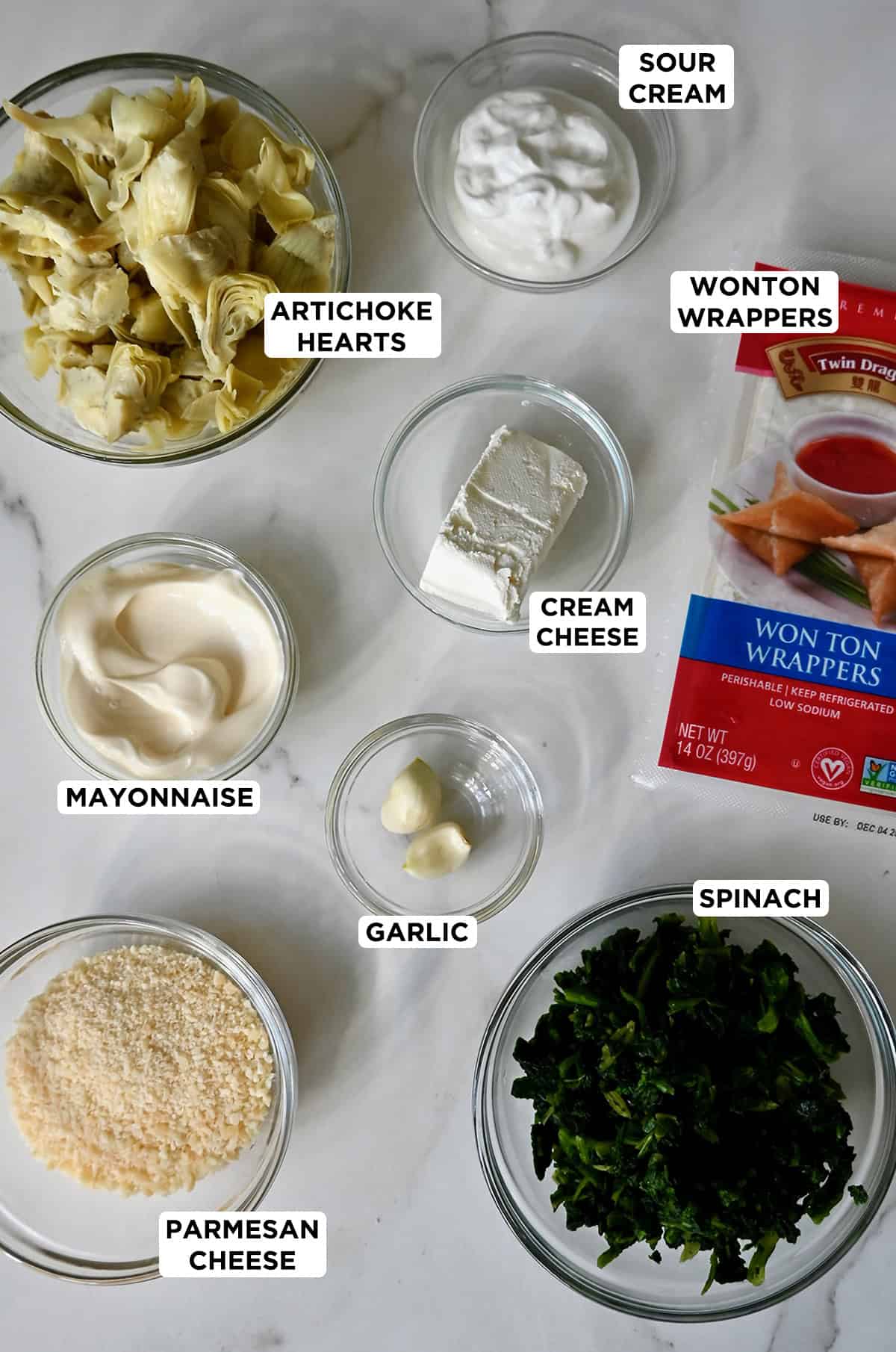 Ingredients needed to make spinach artichoke dip wonton cups.
