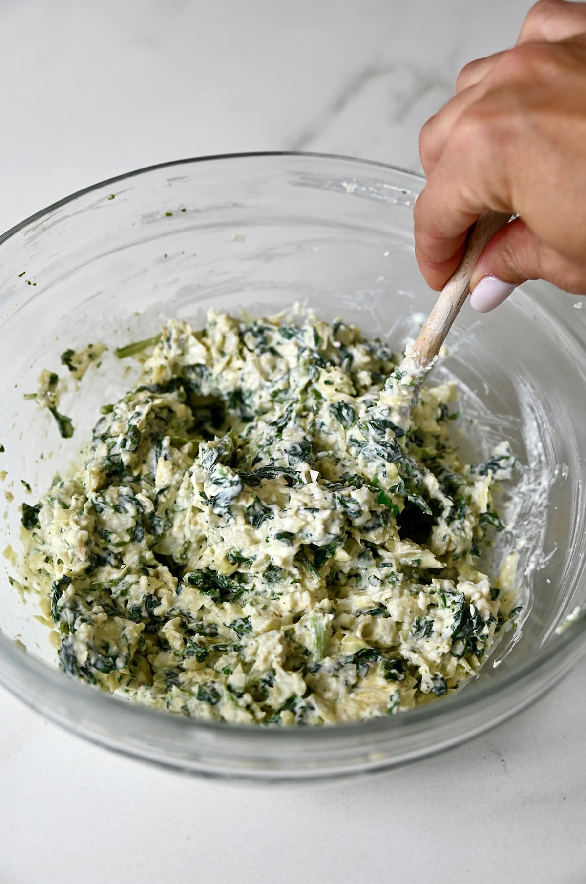 Creamy spinach artichoke dip in a bowl.