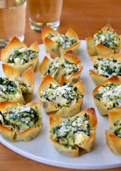 Spinach-Artichoke Dip Wonton Cups on a white serving plate.
