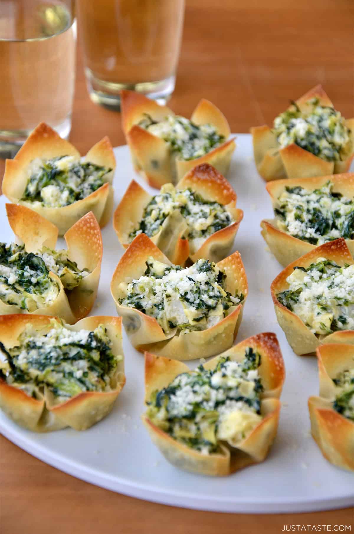 Spinach-Artichoke Dip Wonton Cups on a white serving plate.