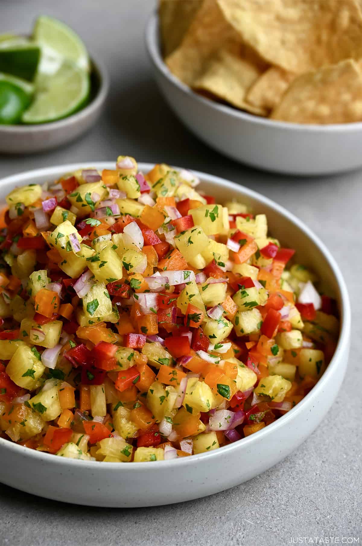 A white bowl containing pineapple salsa garnished with fresh cilantro.