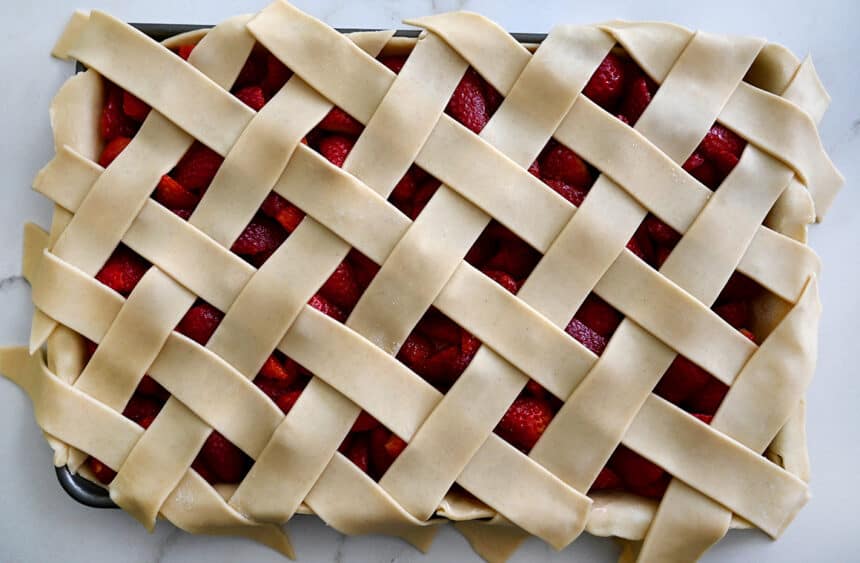 A top-down view of an unbaked slab pie