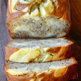 A loaf of cream cheese banana bread cut into perfect slices.