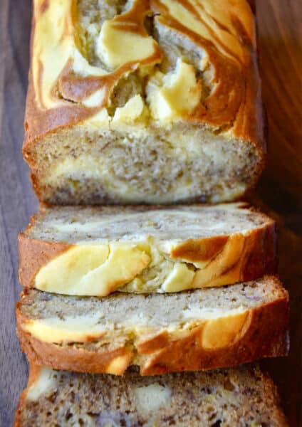 A loaf of cream cheese banana bread cut into perfect slices.