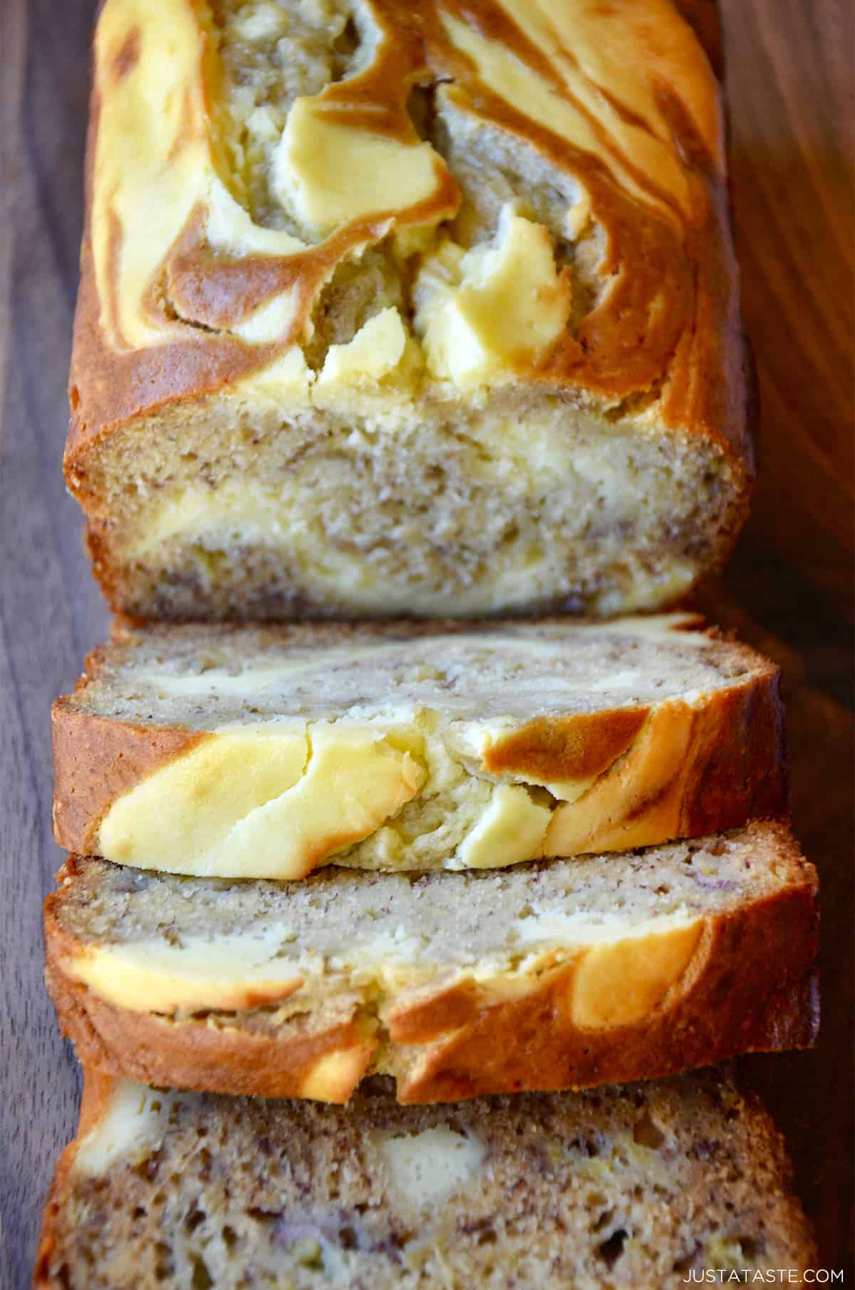 A loaf of cream cheese banana bread cut into perfect slices.