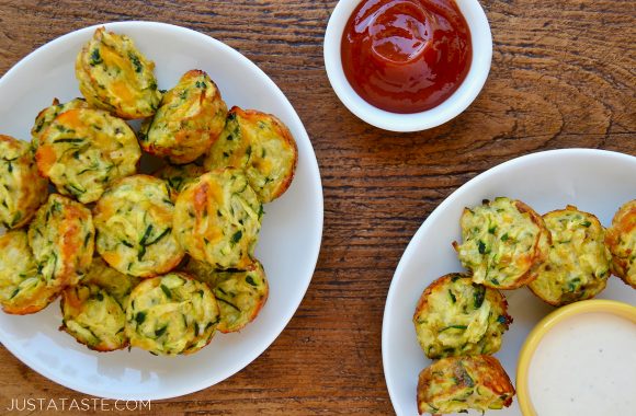 Cheesy Baked Zucchini Tots on white serving plates with ketchup and Ranch dressing