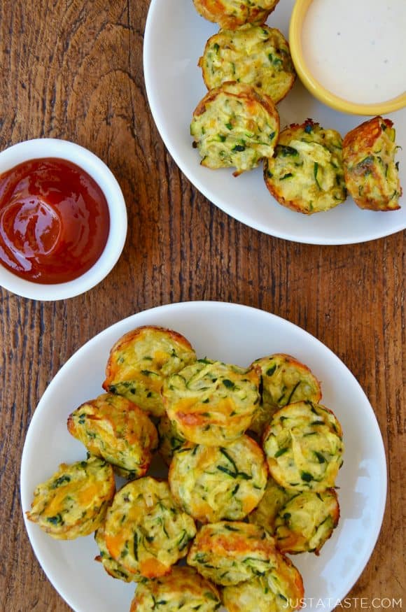 Cheesy Baked Zucchini Tots on white plate next to small bowl with ketchup