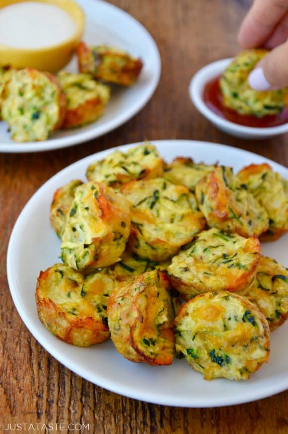 Pile of Cheesy Baked Zucchini Tots on white plate