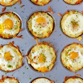 Cheesy Hash Brown Cups with Baked Eggs in a muffin tin