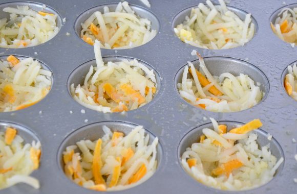 Cheesy hash brown cups mixture in muffin tin